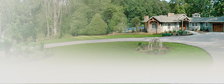 Charming residential home with lush landscaping and circular driveway