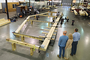 Couple observing the prefabrication of their custom home inside Topsider’s manufacturing facility
