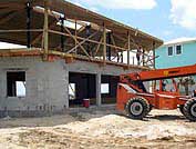 Ocean front hurricane proof elevated house built with an enclosed ground level for parking and storage with flood vents to allow the free flow of water.