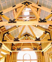 Massive timber post & beam foyer under construction in a custom Topsider home.
