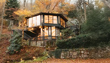 Topsider home in Boone, North Carolina, with an enclosed daylight lower-level foundation on a sloping lakefront site