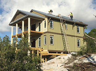 Traditional Florida two-story post & beam stilt beach house under construction, engineered to be hurricane-resistant.