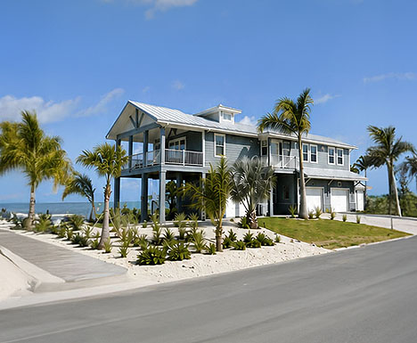 Elevated beach front Florida Keys stilt home design with enclosed ground-level garage area