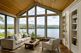 Lake house interior with expansive glass overlooking the water