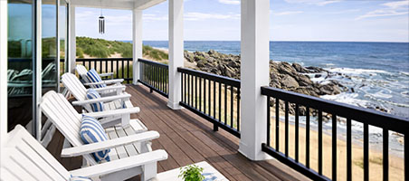 Waterfront home deck and outdoor living area overlooking the water