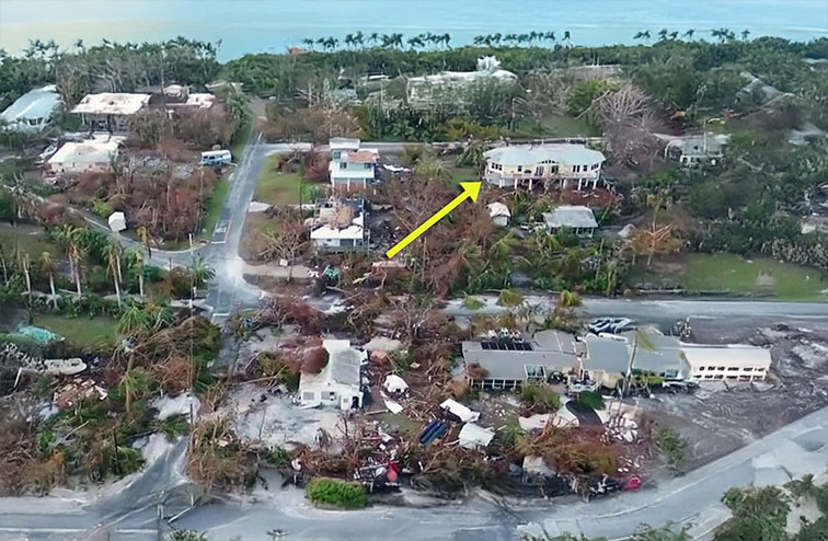 Aerial photo after Hurricane Irma showing a Topsider home still standing amid destroyed surrounding homes in Marathon, Florida