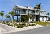 Florida Keys Elevated Stilt Home | Hurricane-Resistant Coastal Design Elevated stilt home in the Florida Keys with turquoise water views, built to withstand hurricane-force winds — Topsider's post-and-beam pedestal design combines coastal durability with tropical island living.