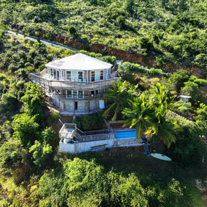 Hillside Ocean Bay View | Hurricane-Resistant Topsider Home on St. John, US Virgin Islands Two-story hurricane-resistant Topsider Home on hillside overlooking turquoise bay and beach on St. John, US Virgin Islands