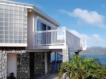 Hurricane-Resistant Topsider Home on St. John, US Virgin Islands | Hillside Ocean Views Completed two-story hurricane-resistant Topsider Home built into the hillside on St. John, US Virgin Islands, with wraparound deck and panoramic ocean views