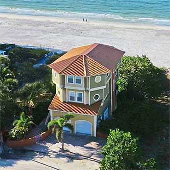 Florida hurricane-resistant beach houses built on concrete pilings with break-away walls with flood vents on the ground level.