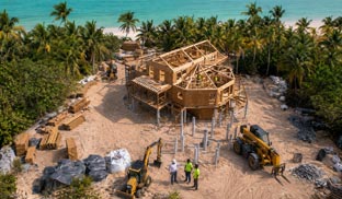 Topsider prefab home kit under construction on a remote Bahamas coastal site