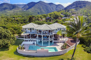 Sprawling multi-level, custom-designed Topsider home with pool against the mountains of Hawaii