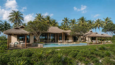 Topsider hurricane-proof prefab tropical villa with thatched roof beside a pool