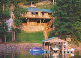 Elevated pedestal house on severely sloping lake lot.