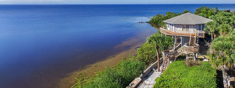 Canal-front pedestal home in Florida, individually designed and engineered for its coastal waterfront homesite by Topsider