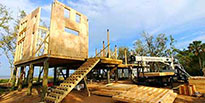 Pre-assembled wall panels being installed by local builders during construction of a Topsider custom home.