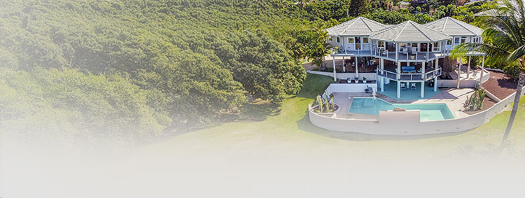 Aerial view of a Topsider multi-sided, post-and-beam home overlooking a pool in a lush tropical setting—engineered for strength, durability, and panoramic views.