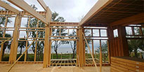 Floor panels, wall panels and massive post & beam structural members assembled on site for a Topsider custom home.